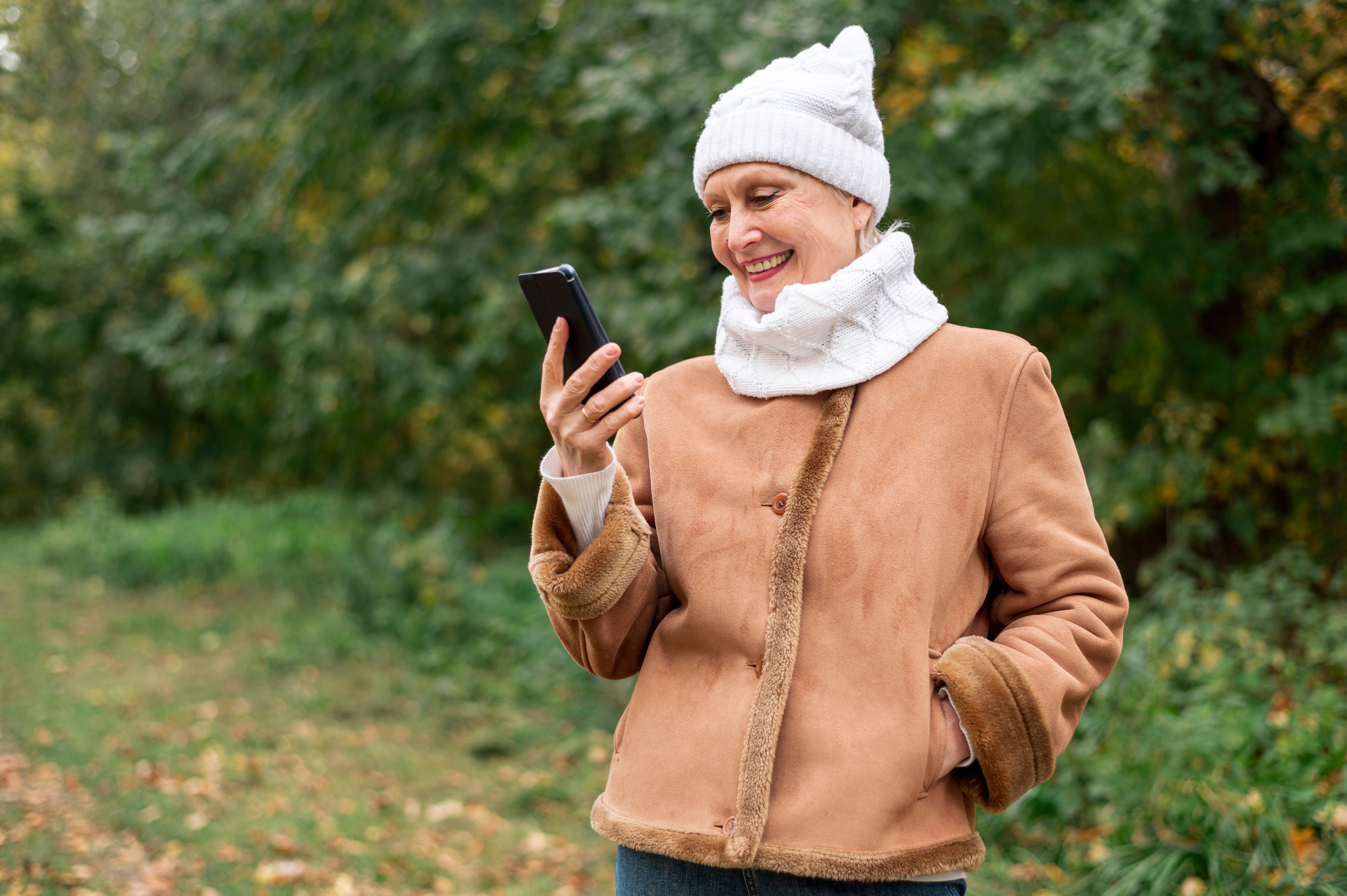 files/low-angle-smiley-female-senior-looking-phone.jpg